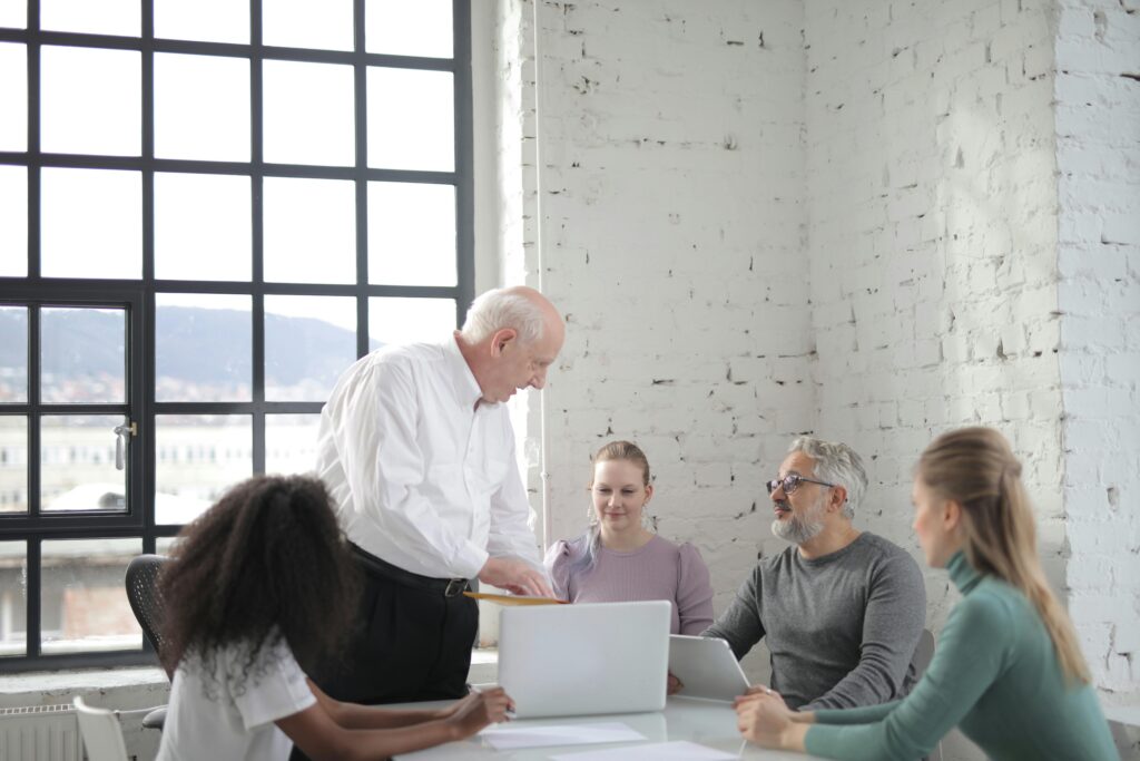 Business leader mentoring team members during a professional development meeting.