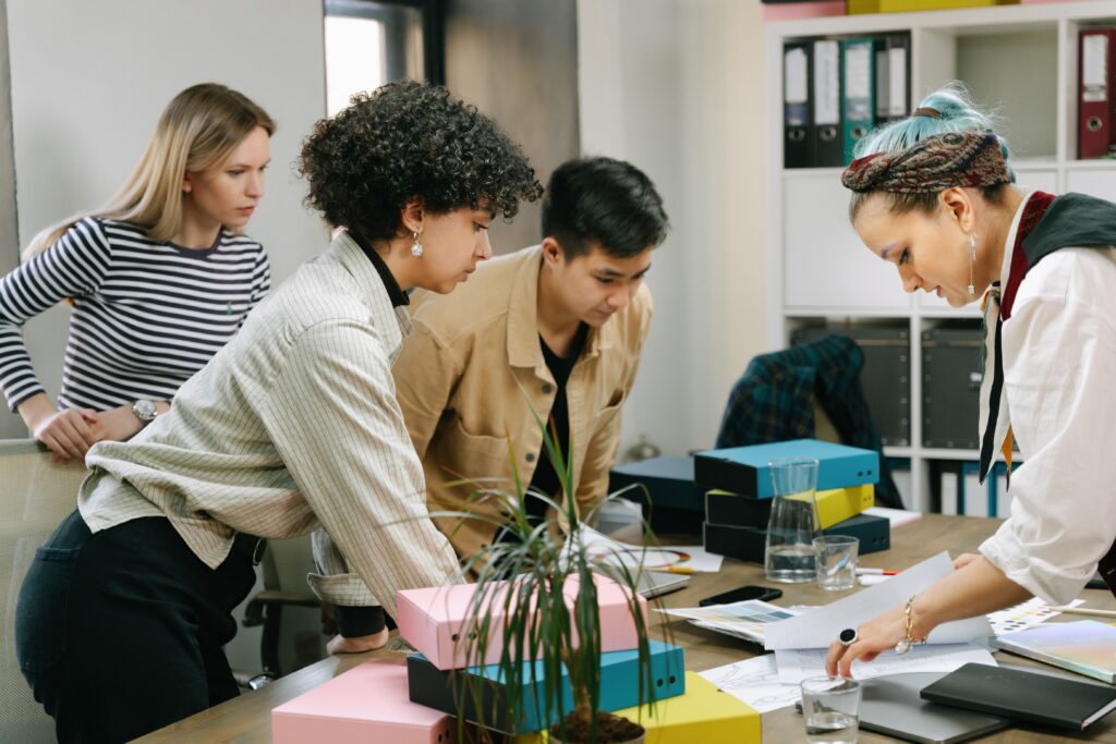 Team members collaborating in a modern workplace culture built on communication, mentorship, and shared goals